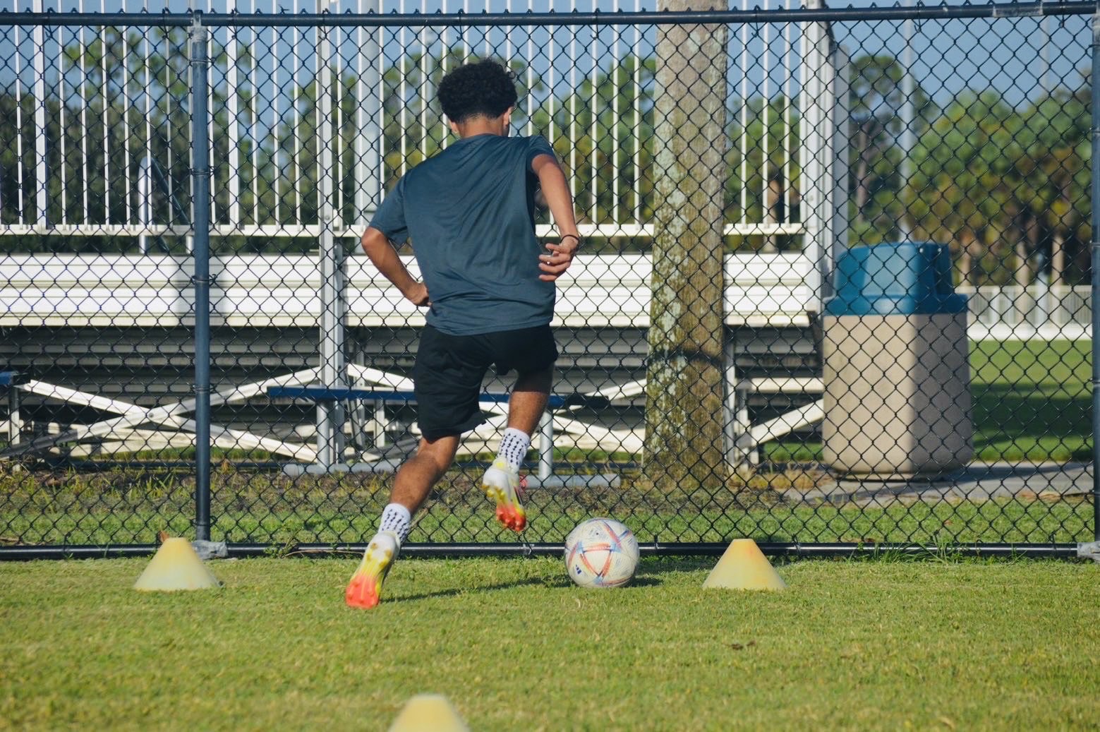 Player working on ball control between cones